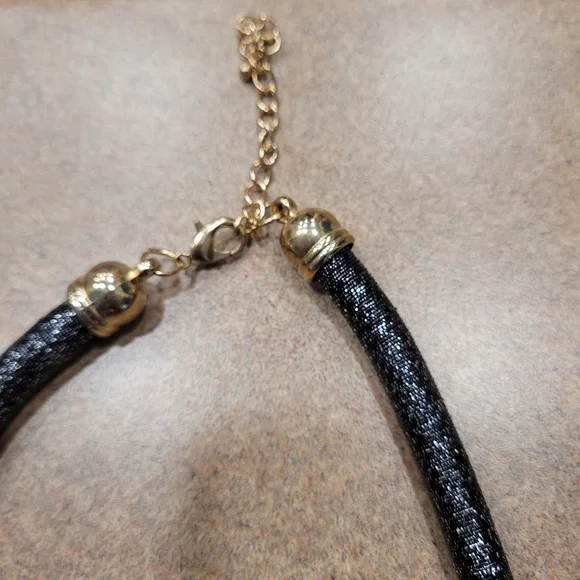 Black rope necklace with gold medal, black, and gray circle. - Picture 2 of 6